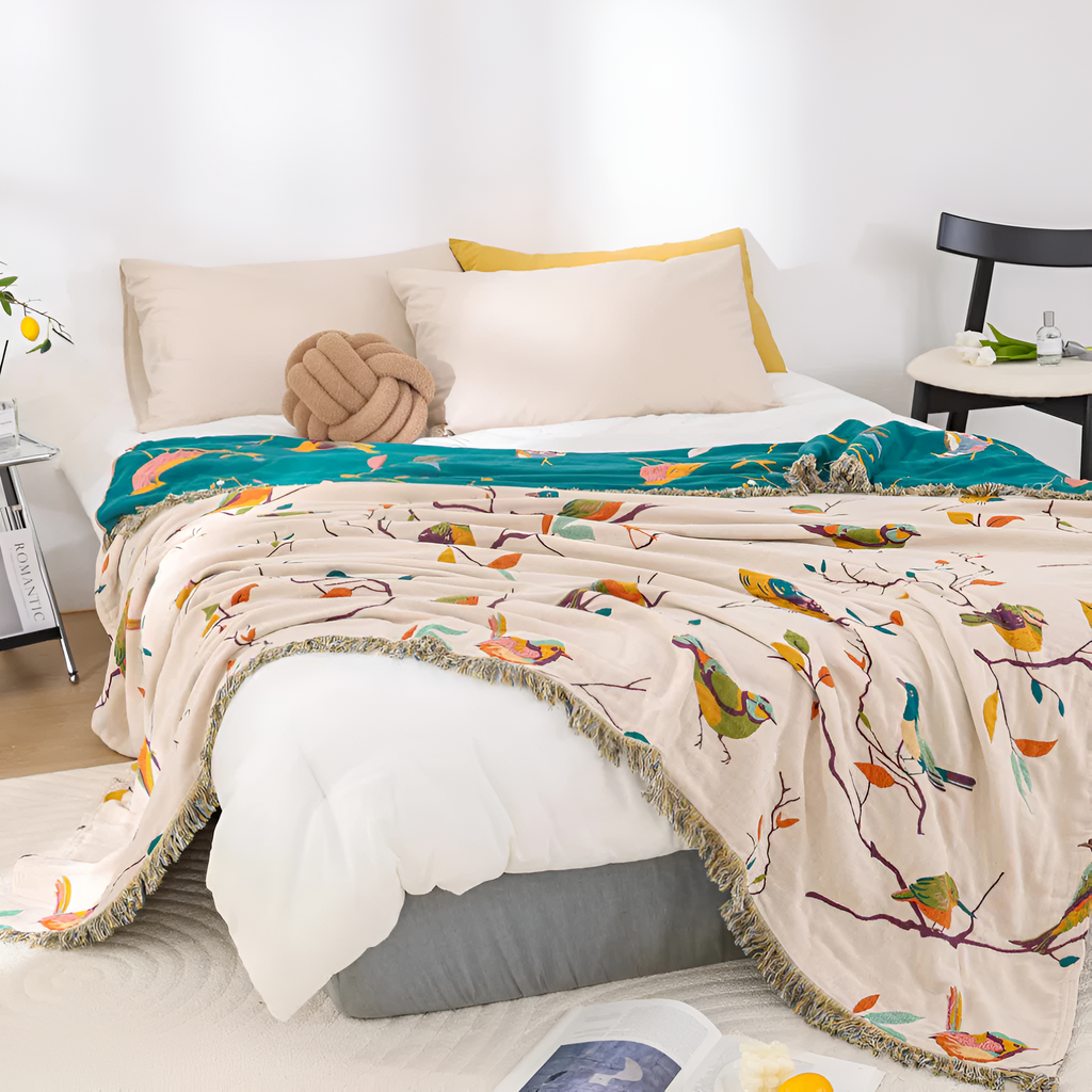 Plaid en coton à pompons motif oiseaux