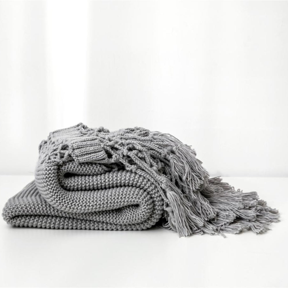 Plaid tricoté tissé à pompons