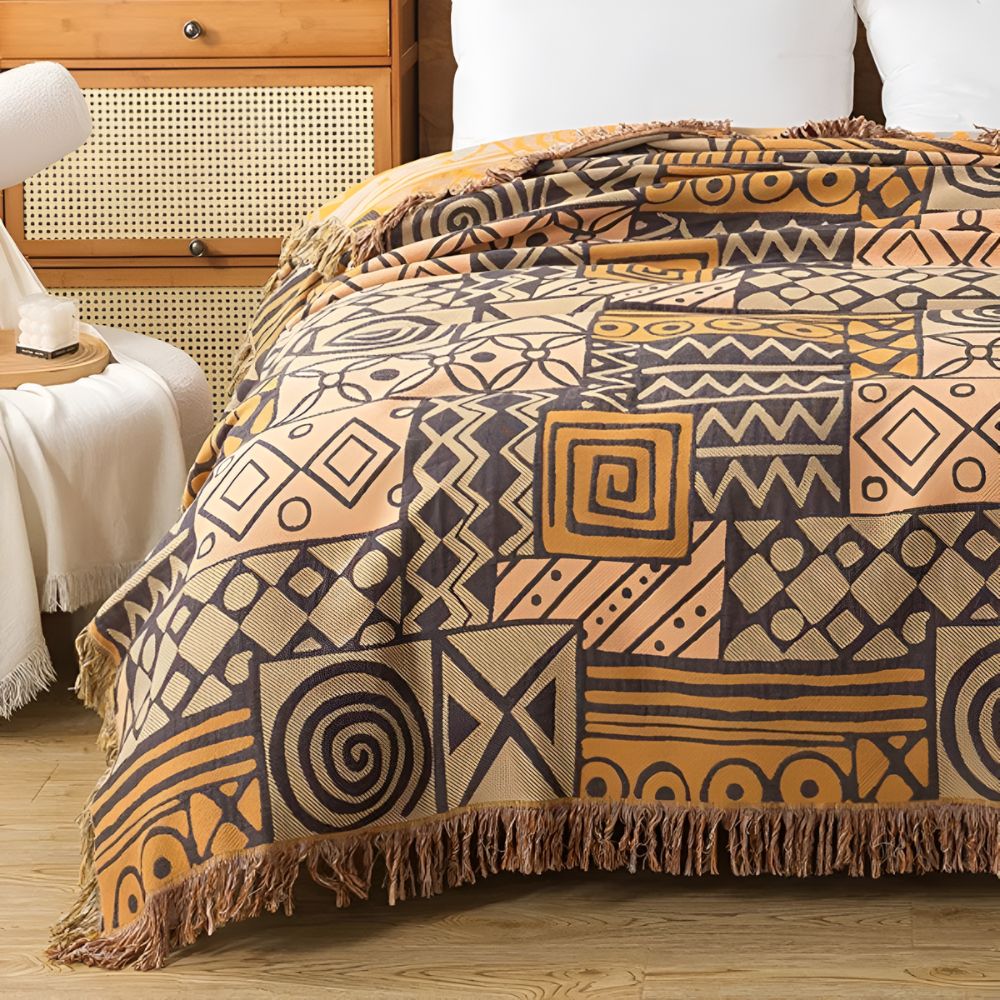 Plaid réversible en coton patchwork tribal à pompons