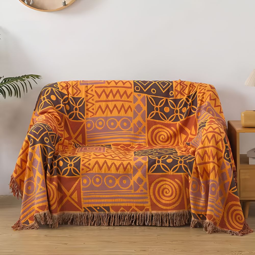 Plaid réversible en coton patchwork tribal à pompons