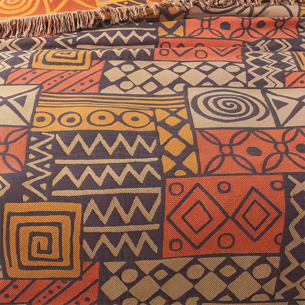 Plaid réversible en coton patchwork tribal à pompons