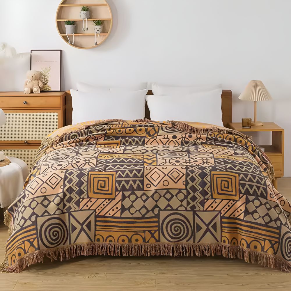 Plaid réversible en coton patchwork tribal à pompons